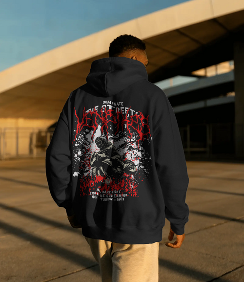 Person wearing a black hoodie with VenBikes designs, walking under a bridge.